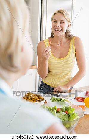 Woman Talking To Friend While Preparing meal, mealtime View Large Photo Image Stock Image - Woman Talking To Friend While Preparing meal, mealtime. Fotosearch