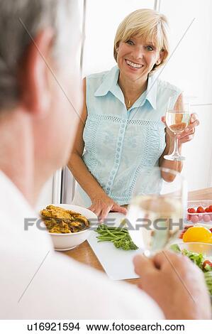 Woman Talking To Husband As She Prepares A meal, mealtime View Large Photo Image Picture - Woman Talking To Husband As She Prepares A meal, mealtime. Fotosearch