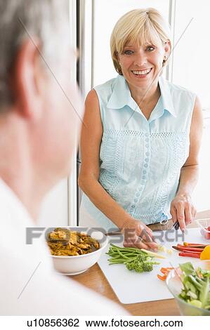 Woman Talking To Husband As She Prepares A meal, mealtime View Large Photo Image Stock Image - Woman Talking To Husband As She Prepares A meal, mealtime. Fotosearch