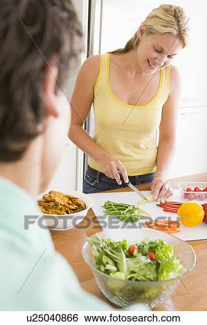 Woman Talking To Husband While Preparing meal, mealtime View Large Photo Image Stock Photograph - Woman Talking To Husband While Preparing meal, mealtime. Fotosearch