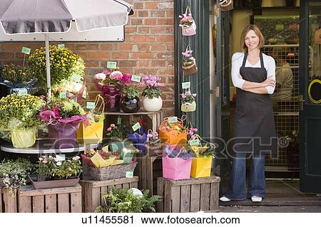 Woman working at flower shop smiling View Large Photo Image Stock Image - Woman working at flower shop smiling. Fotosearch