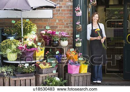 Woman working at flower shop smiling View Large Photo Image Stock Image - Woman working at flower shop smiling. Fotosearch