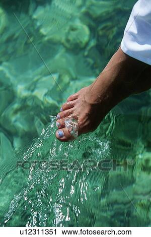 Woman's foot outdoors dipping into water (selective focus) View Large Photo Image Stock Image - Woman's foot outdoors dipping into water (selective focus). Fotosearch