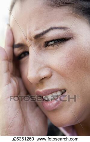 Stock Image - Woman's frustrated face outdoors (selective focus). Fotosearch