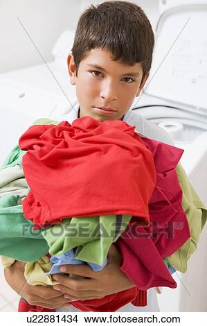 Young Boy Holding A Pile Of Laundry View Large Photo Image Picture - Young Boy Holding A Pile Of Laundry. Fotosearch