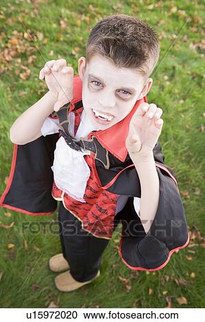 Young boy outdoors wearing vampire costume on Halloween View Large Photo Image Stock Image - Young boy outdoors wearing vampire costume on Halloween. Fotosearch