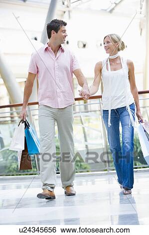 Stock Photograph - Young couple at a shopping mall. Fotosearch