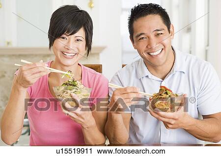 Stock Image - Young Couple Enjoying Chinese Food. Fotosearch