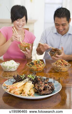 Stock Photography - Young Couple Enjoying Chinese Food. Fotosearch
