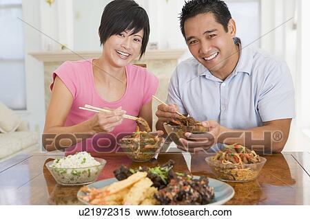 Stock Photography - Young Couple Enjoying Chinese Food. Fotosearch