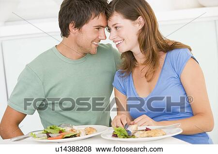 Young Couple Enjoying meal, mealtime Together View Large Photo Image Stock Photo - Young Couple Enjoying meal, mealtime Together. Fotosearch