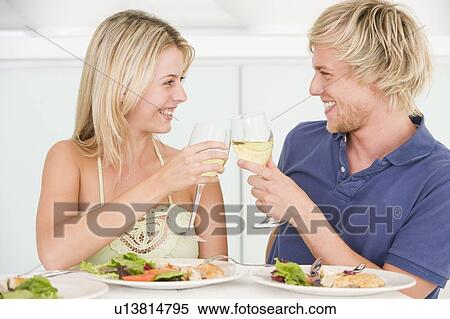 Young Couple Enjoying meal, mealtime With A Glass Of Wine View Large Photo Image Stock Photography - Young Couple Enjoying meal, mealtime With A Glass Of Wine. Fotosearch