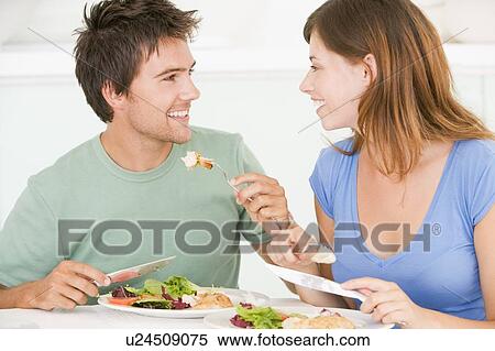 Stock Photography - Young Couple Enjoying meal, mealtime Together. Fotosearch
