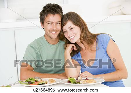Stock Photography - Young Couple Enjoying meal, mealtime Together. Fotosearch