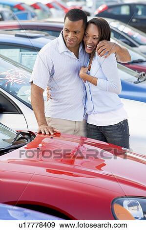 Young couple shopping for a new car View Large Photo Image Stock Photo - Young couple shopping for a new car. Fotosearch