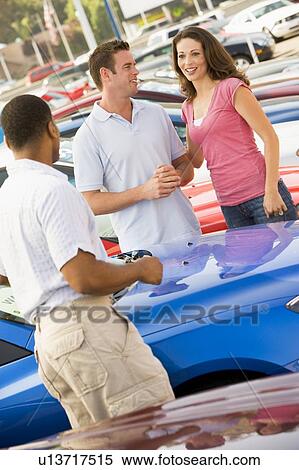Stock Photography - Young couple shopping for a new car. Fotosearch