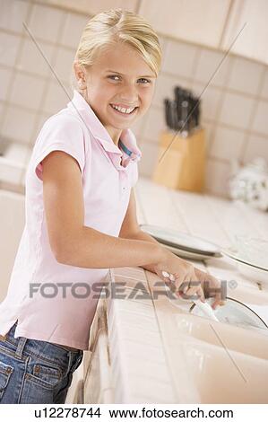Picture - Young Girl Cleaning Dishes, . Fotosearch