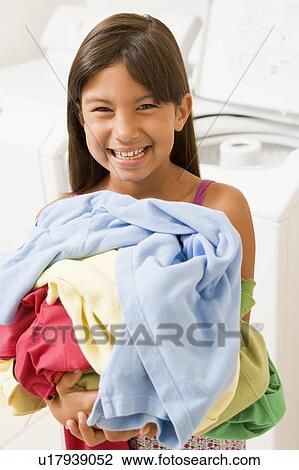 Stock Image - Young Girl Doing Laundry. Fotosearch