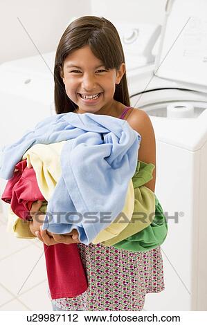 Stock Image - Young Girl Doing Laundry. Fotosearch