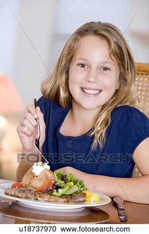 Young Girl Eating meal, mealtime View Large Photo Image Stock Image - Young Girl Eating meal, mealtime . Fotosearch