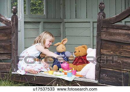 Young girl in shed playing tea and smiling View Large Photo Image Stock Image - Young girl in shed playing tea and smiling. Fotosearch