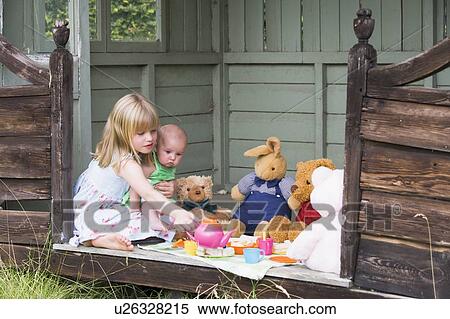 Young girl in shed with baby playing tea View Large Photo Image Stock Photography - Young girl in shed with baby playing tea. Fotosearch