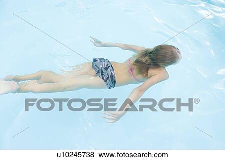 Young girl in swimming pool underwater View Large Photo Image Stock Photo - Young girl in swimming pool underwater. Fotosearch