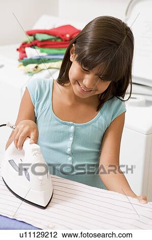 Stock Image - Young Girl Ironing . Fotosearch