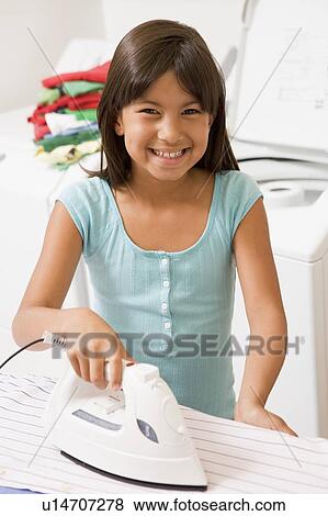 Stock Photo - Young Girl Ironing . Fotosearch