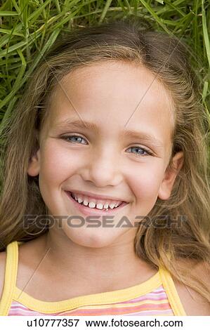 Young Girl Lying Down On The Grass View Large Photo Image Stock Photo - Young Girl Lying Down On The Grass. Fotosearch