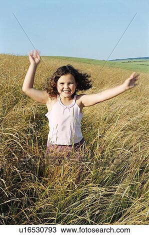 Young girl running outdoors smiling View Large Photo Image Stock Image - Young girl running outdoors smiling. Fotosearch