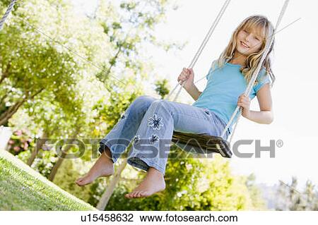 Young girl sitting on swing smiling View Large Photo Image Stock Image - Young girl sitting on swing smiling. Fotosearch