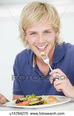 Young Man Enjoying meal, mealtime View Large Photo Image Stock Image - Young Man Enjoying meal, mealtime. Fotosearch