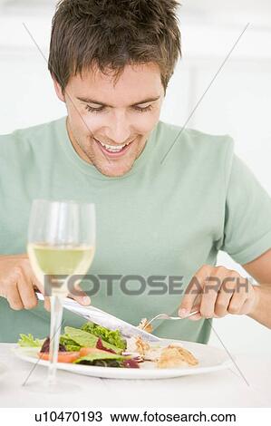 Young Man Enjoying meal, mealtime With A Glass Of Wine View Large Photo Image Stock Image - Young Man Enjoying meal, mealtime With A Glass Of Wine. Fotosearch