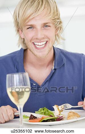 Young Man Enjoying meal, mealtime With A Glass Of Wine View Large Photo Image Stock Image - Young Man Enjoying meal, mealtime With A Glass Of Wine. Fotosearch