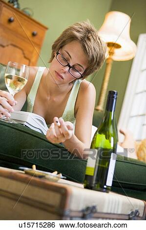 Young woman at home smoking and drinking wine by telephone View Large Photo Image Stock Photograph - Young woman at home smoking and drinking wine by telephone. Fotosearch