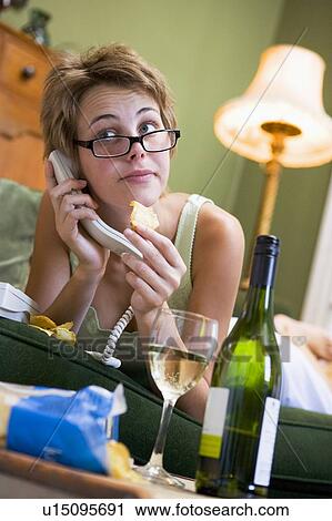 Young woman at home talking on telephone View Large Photo Image Stock Image - Young woman at home talking on telephone. Fotosearch