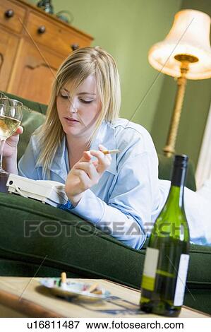 Stock Photo - Young woman at home waiting by telephone. Fotosearch