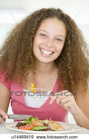 Young Woman Enjoying Healthy meal, mealtime View Large Photo Image Stock Photo - Young Woman Enjoying Healthy meal, mealtime. Fotosearch