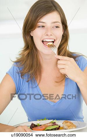 Young Woman Enjoying meal, mealtime View Large Photo Image Picture - Young Woman Enjoying meal, mealtime. Fotosearch