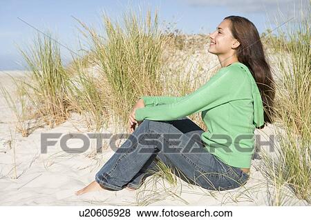 Young woman posing on a sand hill View Large Photo Image Stock Photo - Young woman posing on a sand hill. Fotosearch