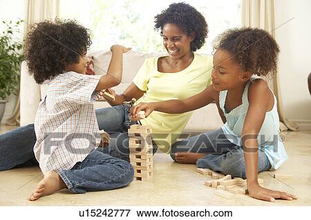 Brother And Sister Playing Game With Mother At Home View Large Photo Image Stock Photo - Brother And Sister Playing Game With Mother At Home. Fotosearch