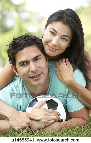 Stock Image - Couple In Park With Football. Fotosearch