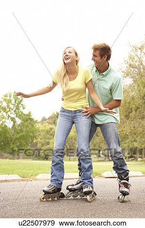 Couple Wearing In Line Skates In Park View Large Photo Image Stock Photo - Couple Wearing In Line Skates In Park. Fotosearch