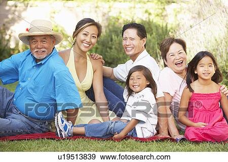 Extended Family Group Relaxing In Garden View Large Photo Image Stock Photo - Extended Family Group Relaxing In Garden. Fotosearch