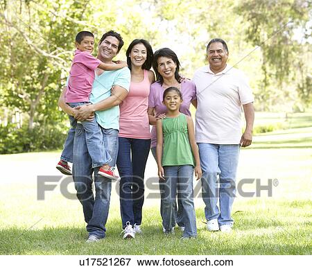 Stock Photo - Extended Family Group Walking In Park. Fotosearch