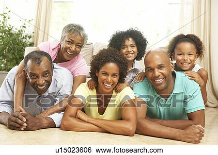 Extended Family Relaxing At Home Together View Large Photo Image Stock Photograph - Extended Family Relaxing At Home Together. Fotosearch