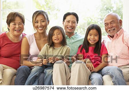Extended Family Relaxing On Sofa At Home Together View Large Photo Image Picture - Extended Family Relaxing On Sofa At Home Together. Fotosearch
