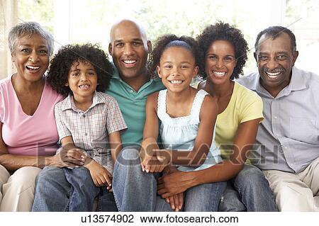 Extended Family Relaxing On Sofa At Home Together View Large Photo Image Stock Image - Extended Family Relaxing On Sofa At Home Together. Fotosearch