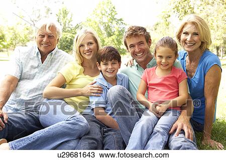 Stock Image - Extended Group Portrait Of Family Enjoying Day In Park. Fotosearch
